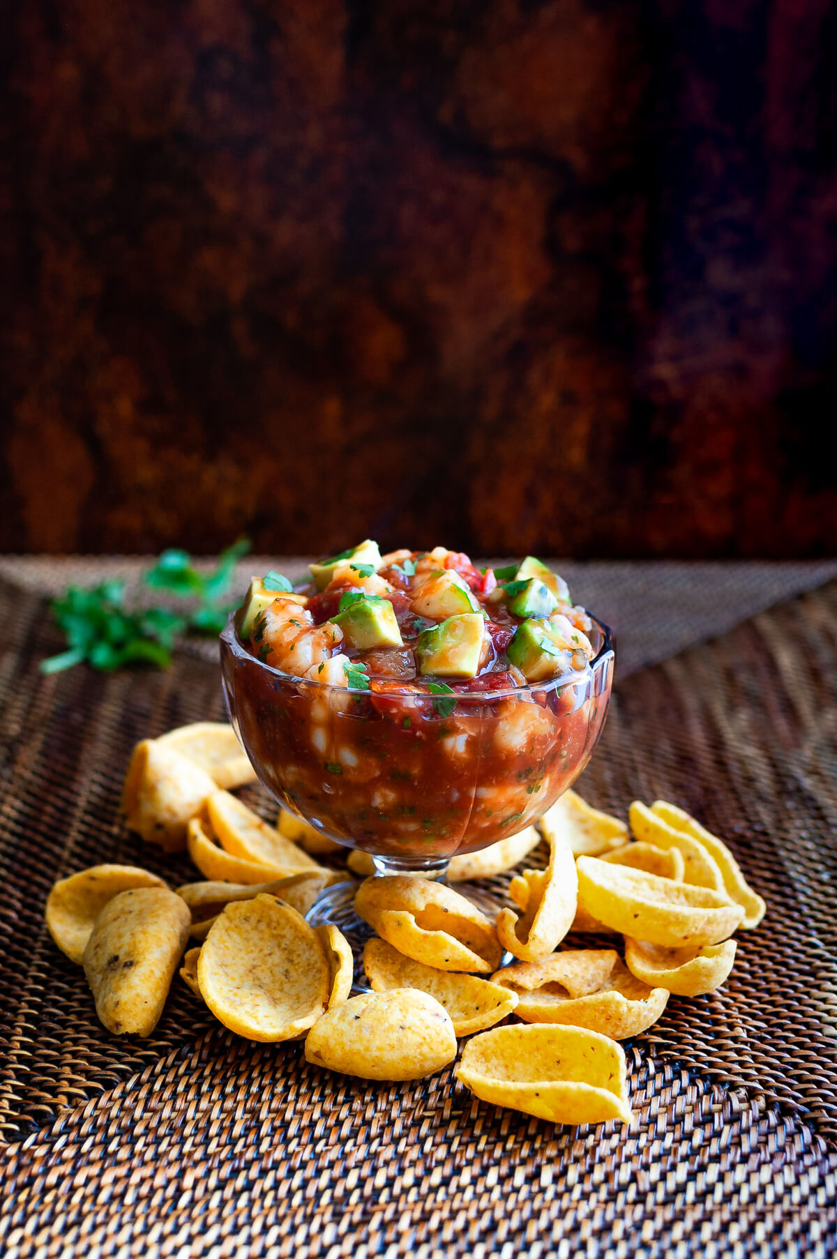 Side view of shrimp campechana in a glass bowl..