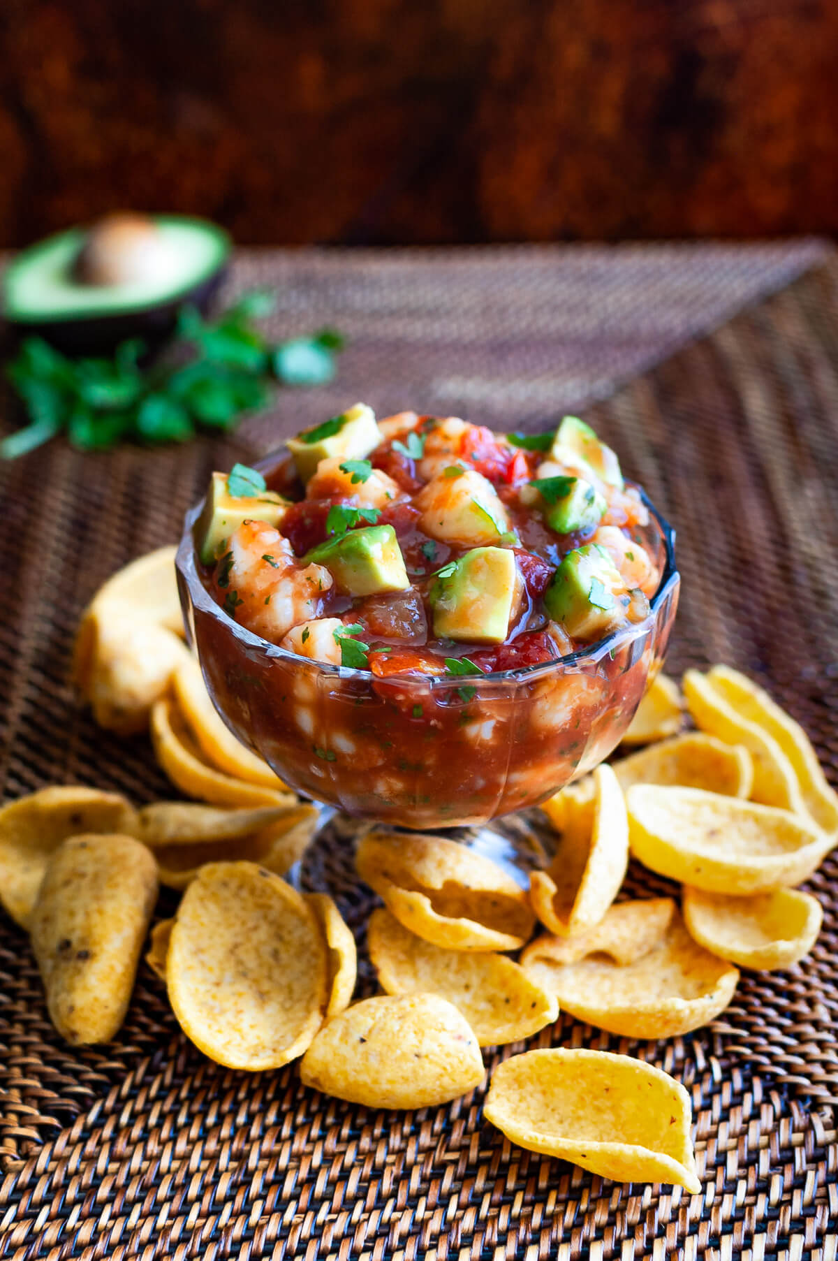 A bowl of shrimp campechana served with some frito chips.