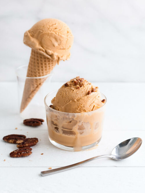 Scoops of dulce de leche ice-cream in a cup and on a cone.