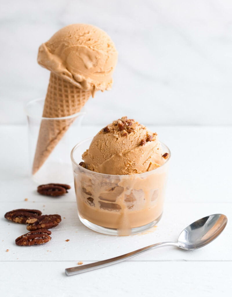 Scoops of dulce de leche ice-cream in a cup and on a cone.
