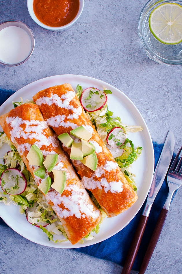 Shrimp enchiladas on a bed of napa slaw and topped with chopped avocados.