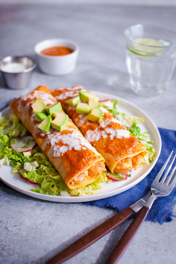 Shrimp enchiladas on a bed of napa slaw and topped with chopped avocados.