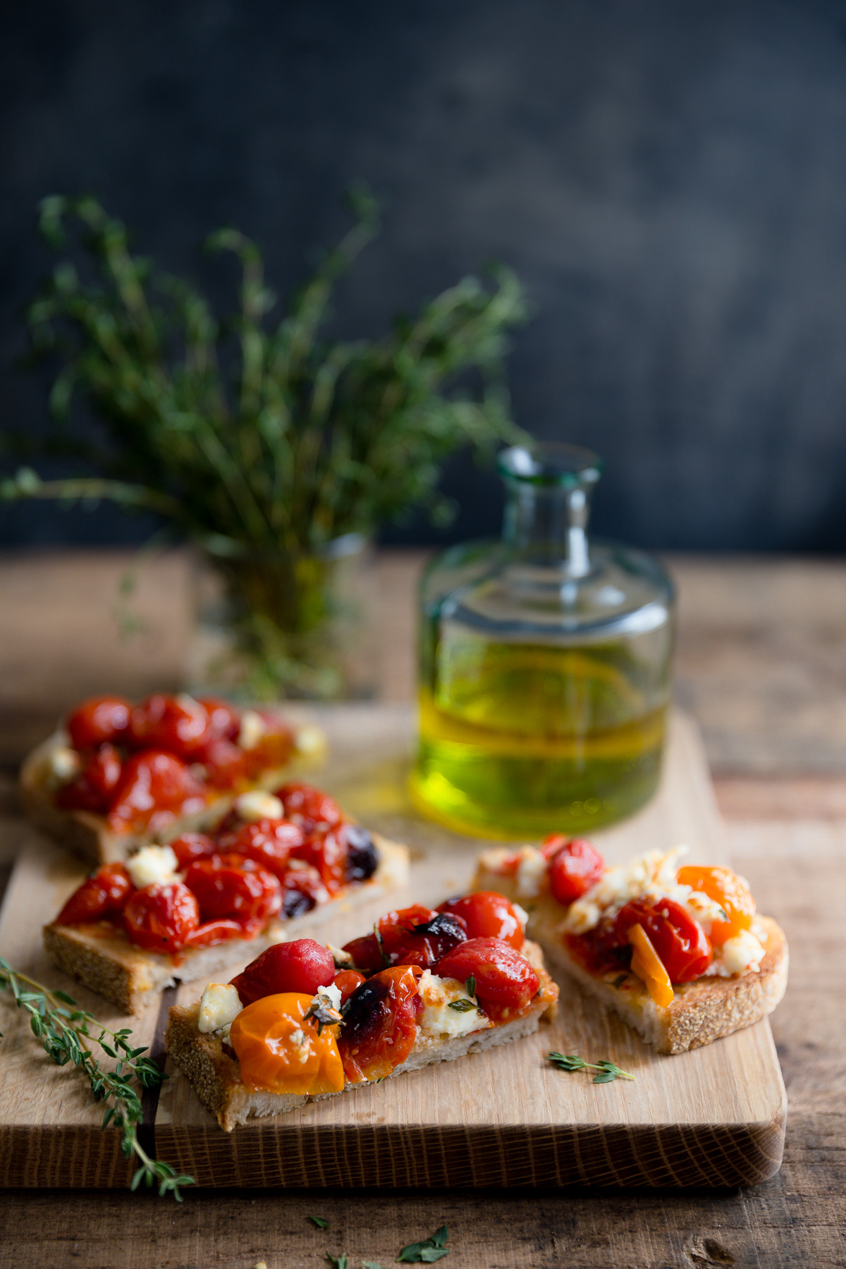 Roasted tomatoes and feta on slices of toasted bread.