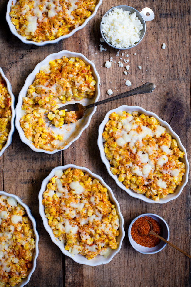 Overhead shot of several ramekins of creamed elote.