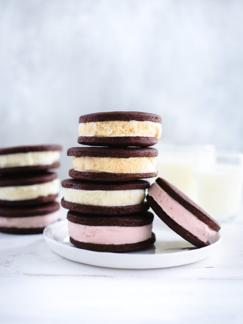 A stack of ice-cream sandwiches on a white plate.