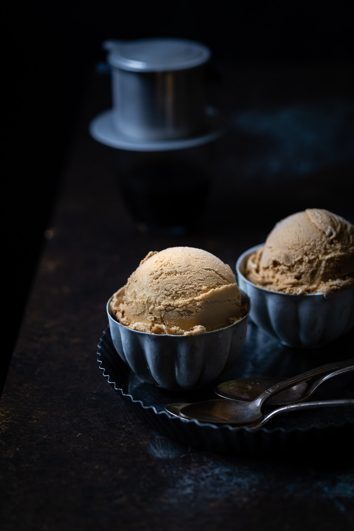 2 bowls of Vietnamese coffee ice-cream on a metal tray.