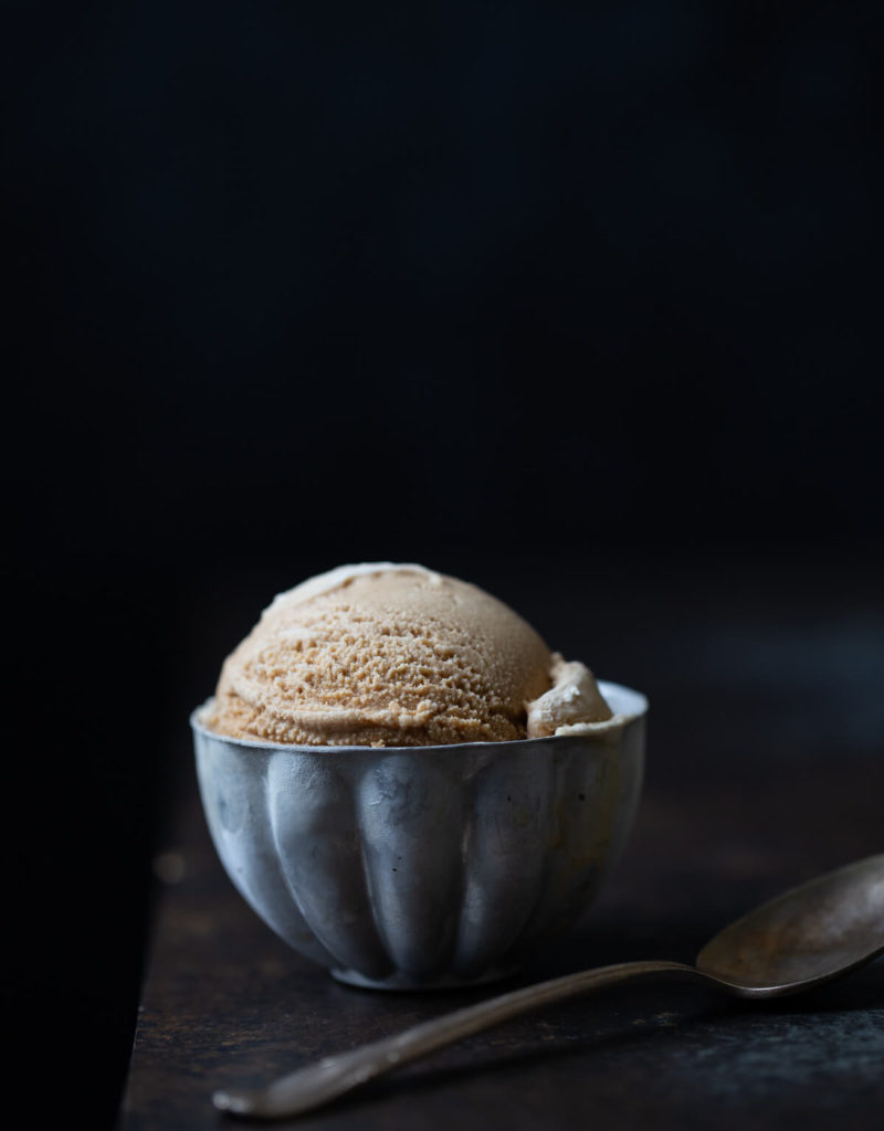 A scoop of Vietnamese coffee ice-cream in a metal cup.