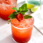 Close-up of two glasses of strawberry mojito.