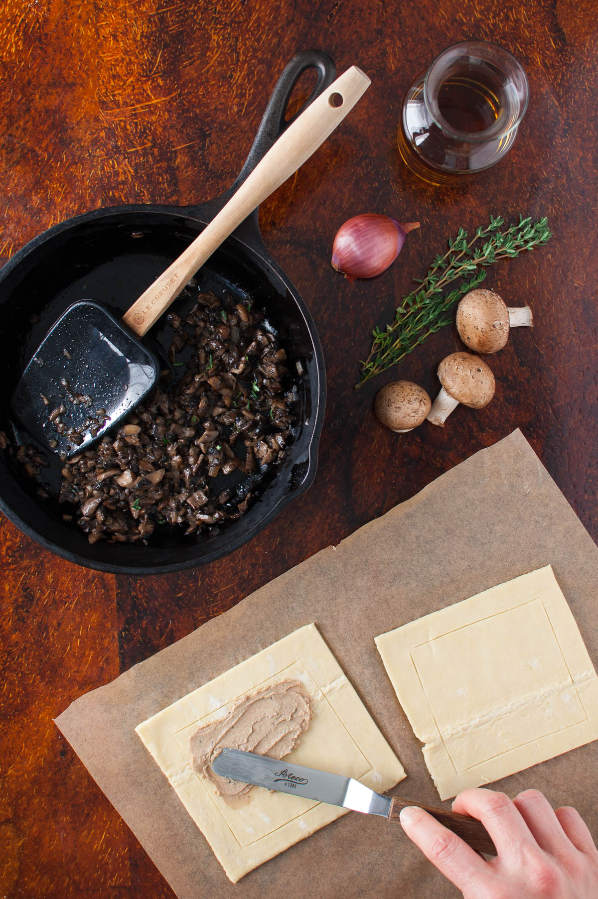 Paté being spread on puff pastry.