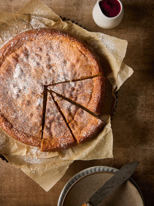 Almond torte with three slices cut.