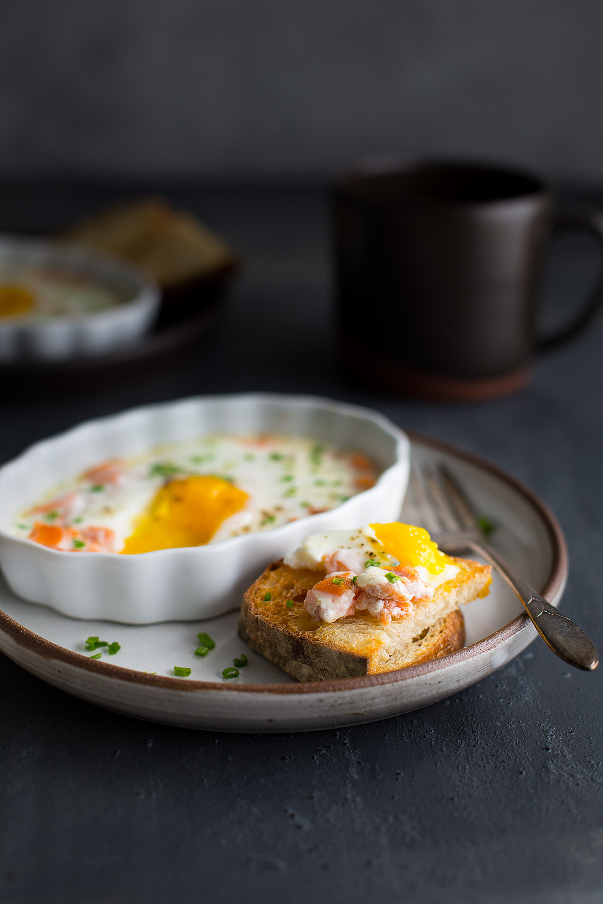 A slice of toast topped with some baked eggs.