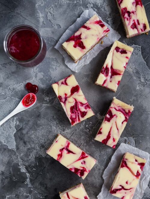Overhead view of some cranberry swirl cheesecake bars.