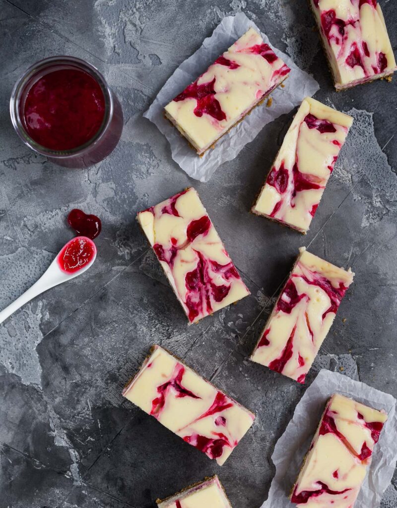Overhead view of some cranberry swirl cheesecake bars.
