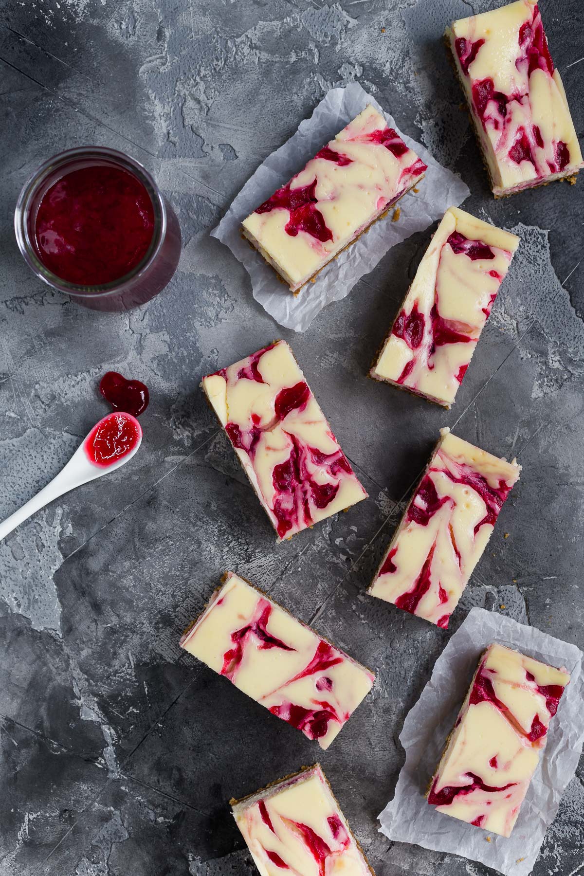 Overhead view of some cranberry swirl cheesecake bars.