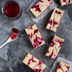 Overhead view of some cranberry swirl cheesecake bars.