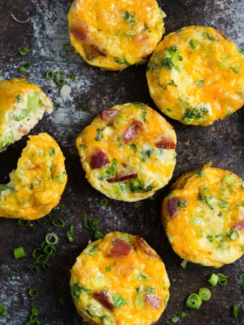 Close-up of mini frittatas on a wooden board.