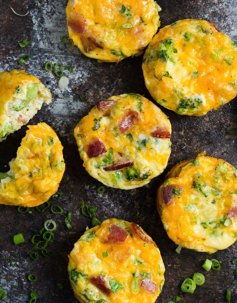 Close-up of mini frittatas on a wooden board.