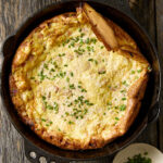 Savory dutch baby in a cast iron skillet.